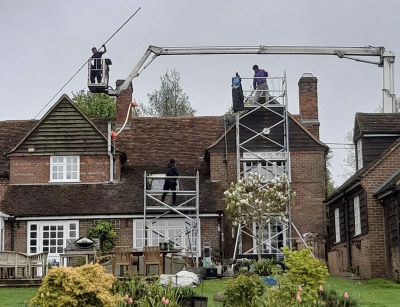 The Moss Cleaners using cherry picker and scaffolding to clean roof safely and professionally in Southwick, West Sussex